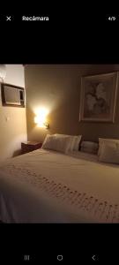 En eller flere senge i et værelse på Pension los amiwuis