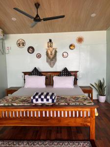 a bedroom with a large bed with a ceiling at Namaste Beach Huts in Patnem