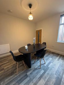 a dining room with a table and chairs at Serenity LTD in Leicester