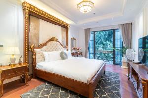 a bedroom with a large bed and a balcony at Victoria Suites Westlake Hanoi in Hanoi +181 photos