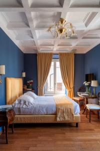a bedroom with a bed with blue walls and a ceiling at Hotel Scalinata Di Spagna in Rome