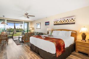 a bedroom with a bed and a living room at Eldorado A108 in Kaanapali +43 photos