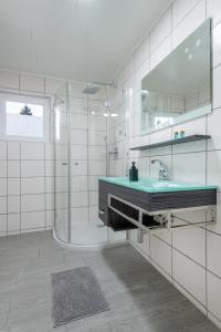 a bathroom with a sink and a shower at Ferienhaus Gehrenblick in Oberletzen