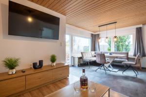 a living room with a large flat screen tv on the wall at Ferienhaus Gehrenblick in Oberletzen