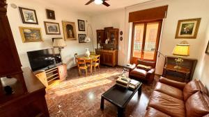 a living room with a couch and a television at B&E Casa Vacanze in Taranto +10 photos