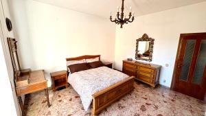 a bedroom with a bed and a mirror and a dresser at B&E Casa Vacanze in Taranto