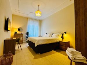 a bedroom with a bed and a desk and a chair at Borgo Pio Suite Apartment in Rome