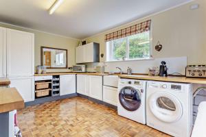 a kitchen with a washer and dryer at Hillside in Kyleakin