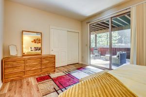 ein Schlafzimmer mit einem Bett und einer Kommode mit Spiegel in der Unterkunft Redwoods Escape with Hot Tub Near Russian River! in Rio Nido