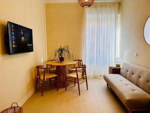 a living room with a table and a couch at Borgo Pio Suite Apartment in Rome