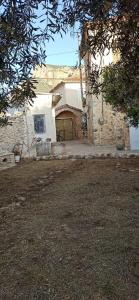 a brick house with a garage in a yard at Eleonoras House in Leonidio