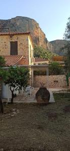 a house with a white canopy and a table and bench at Eleonoras House in Leonidio