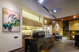 a living room with a tv on a table at Yangshuo The One Hotel- Aesthetic Lifestyle in Yangshuo