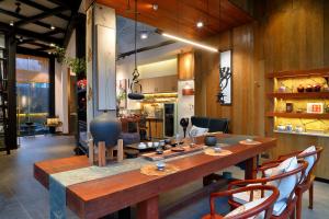 a dining room with a large wooden table and chairs at Yangshuo The One Hotel- Aesthetic Lifestyle in Yangshuo +47 photos