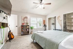 a bedroom with a bed and a ceiling fan at Cozy boho Retreat in Grove City