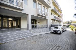 a car parked in front of a building at GGM apartment in Kutaisi
