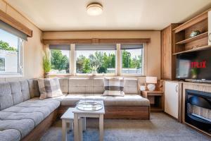 a living room with a couch and a tv at 3 Bed Caravan - Seton Sands in Port Seton