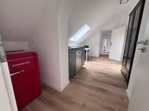 a kitchen with a red refrigerator and a table at Bothfeld Suite in Hannover
