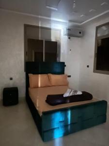 a bedroom with a bed with blue lights on it at Sahara luxury suites in Hassilabied +12 photos