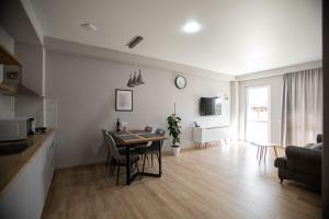 a kitchen and living room with a table and chairs at GGM apartment in Kutaisi