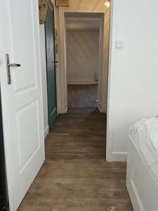 a hallway with a door leading to a room at Appartement coquet à la Machine in La Machine