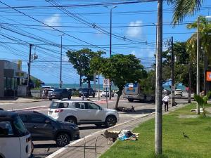a street with cars parked on the side of the road at Pousada Atlântico tambaú praia in João Pessoa