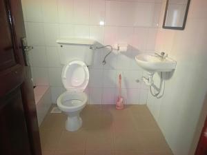 a bathroom with a toilet and a sink at Guardian Motel Kasese in Kasese