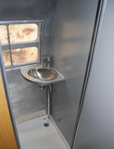 Un baño pequeño con lavabo y ventana. en Love Ride, en Amadora