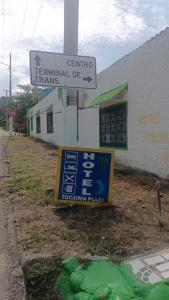a street sign in front of a building with a sign at hotel tocaima plaza in Tocaima