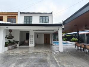 a white building with a patio and a pool at CasaD'Tamarind Homestay with Private Pool in Alor Setar