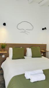 a large white bed with two towels on it at Casa das Andorinhas-Alentejo in Vidigueira