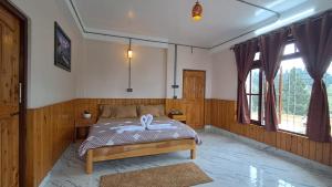 a bedroom with a bed with a white ribbon on it at Red Cherry Homestay in Lava