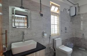 a bathroom with a sink and a toilet at Red Cherry Homestay, Nokdara in Lava
