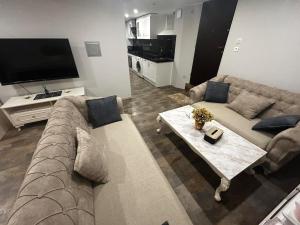 a living room with a couch and a table at Appartement in Oberschaeffolsheim