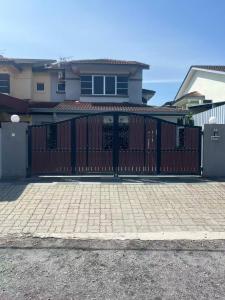 a red gate in front of a house at Leaf Haven Homestay in Ipoh