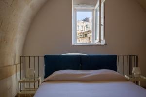 Postel nebo postele na pokoji v ubytování Casamata Matera