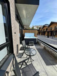 a patio with a table and chairs and a hot tub at Luxury apartment with private jacuzzi and 2 ski passes in Levi! in Levi