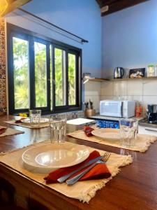a kitchen with a table with a white plate on it at Apê Beira mar: Ar, mirante e Vista Mar – 6 Pessoas in Imbituba