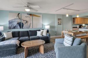 a living room with a couch and a table at Sandpiper 304 in Tybee Island