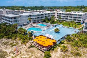 an aerial view of a resort with a pool and umbrellas at The Vue 233 in Tybee Island