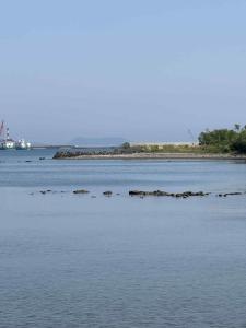 a body of water with an island in the distance at くりのやかた Kuri no Yakata in Minami-ura