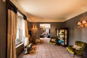 a living room with a couch and chairs in a room at Balmoral Arms in Ballater