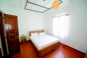 Ένα ή περισσότερα κρεβάτια σε δωμάτιο στο Aurora පාට පාට