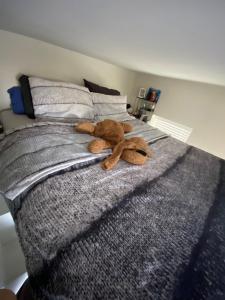 a stuffed animal laying on top of a bed at The Scheveningse Meisjes in Scheveningen