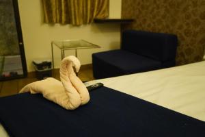 Postel nebo postele na pokoji v ubytování Alphineglow Hotel