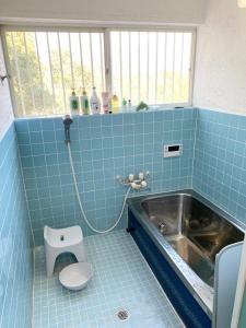 a blue tiled bathroom with a sink and a toilet at ISU BASE - Vacation STAY 12851 in Shima