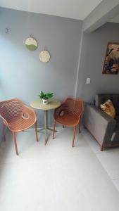 a living room with a couch and a table and chairs at Apartamento Aconchegante e completo em Manaíra in João Pessoa +20 photos