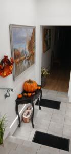 a pumpkin sitting on a table in a hallway at Cichy Zaułek 9A in Brodnica