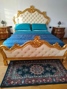 a king sized bed with a blue blanket and blue pillows at One M in Borgarello