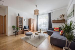 a living room with a couch and a table at Stylish City Stay in Budapest +15 photos
